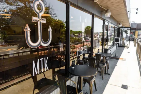 a view of a dining room with furniture wooden floor and a chandelier