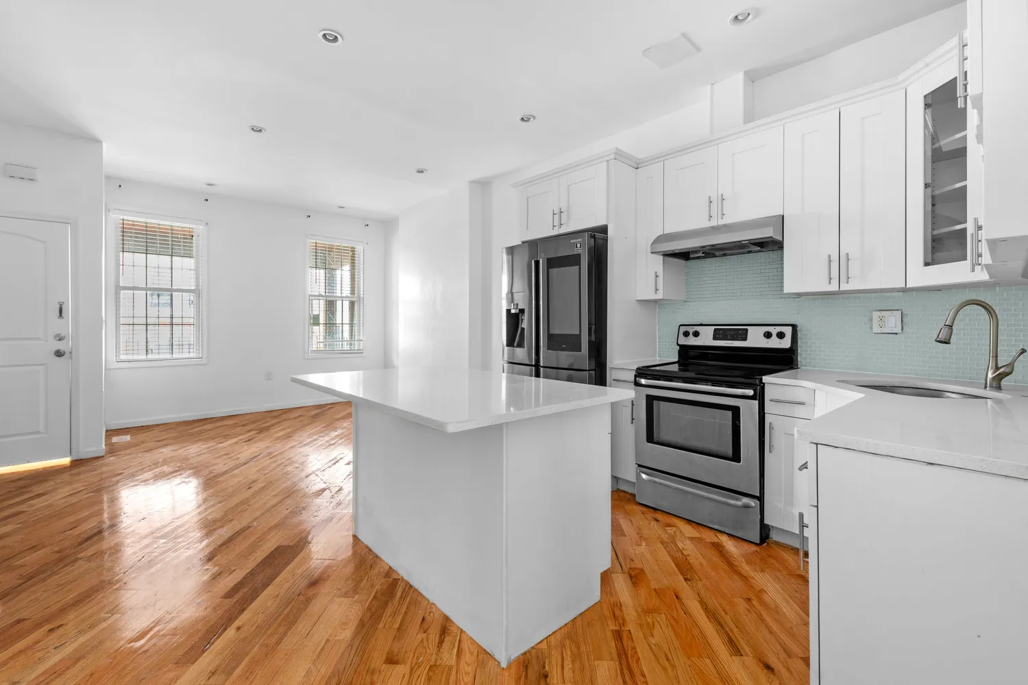 a kitchen with granite countertop white cabinets and appliances