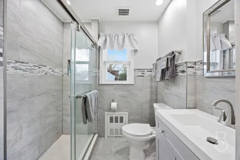 a bathroom with a sink toilet and shower