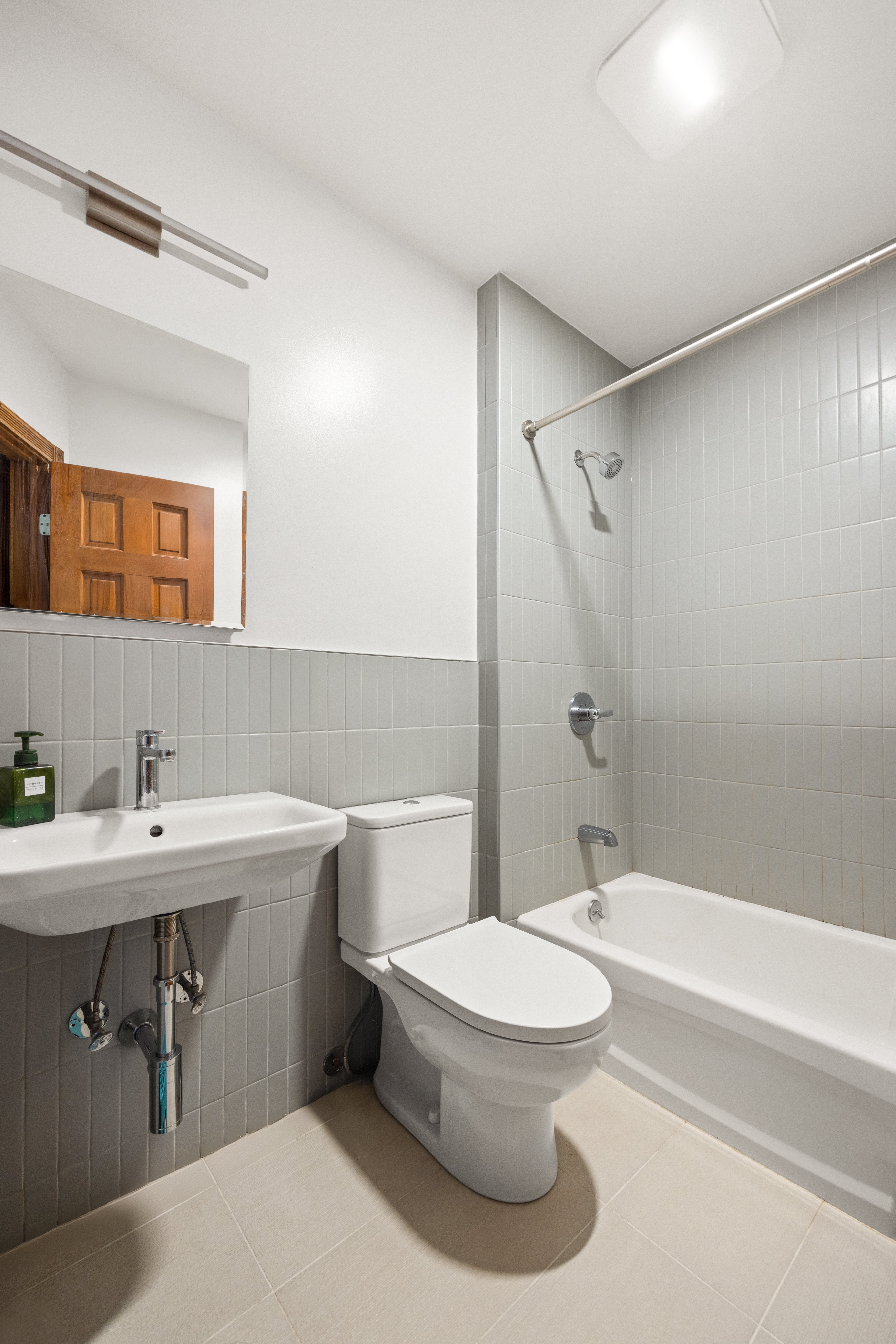 219 16th Street, Unit 1 Brooklyn, NY 11215 - Photo 6 of 7 a bathroom with a sink toilet and shower