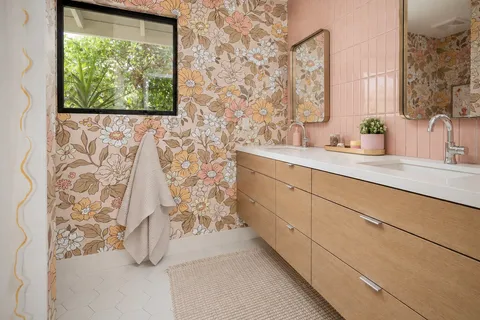 a bathroom with a double vanity sink and a mirror