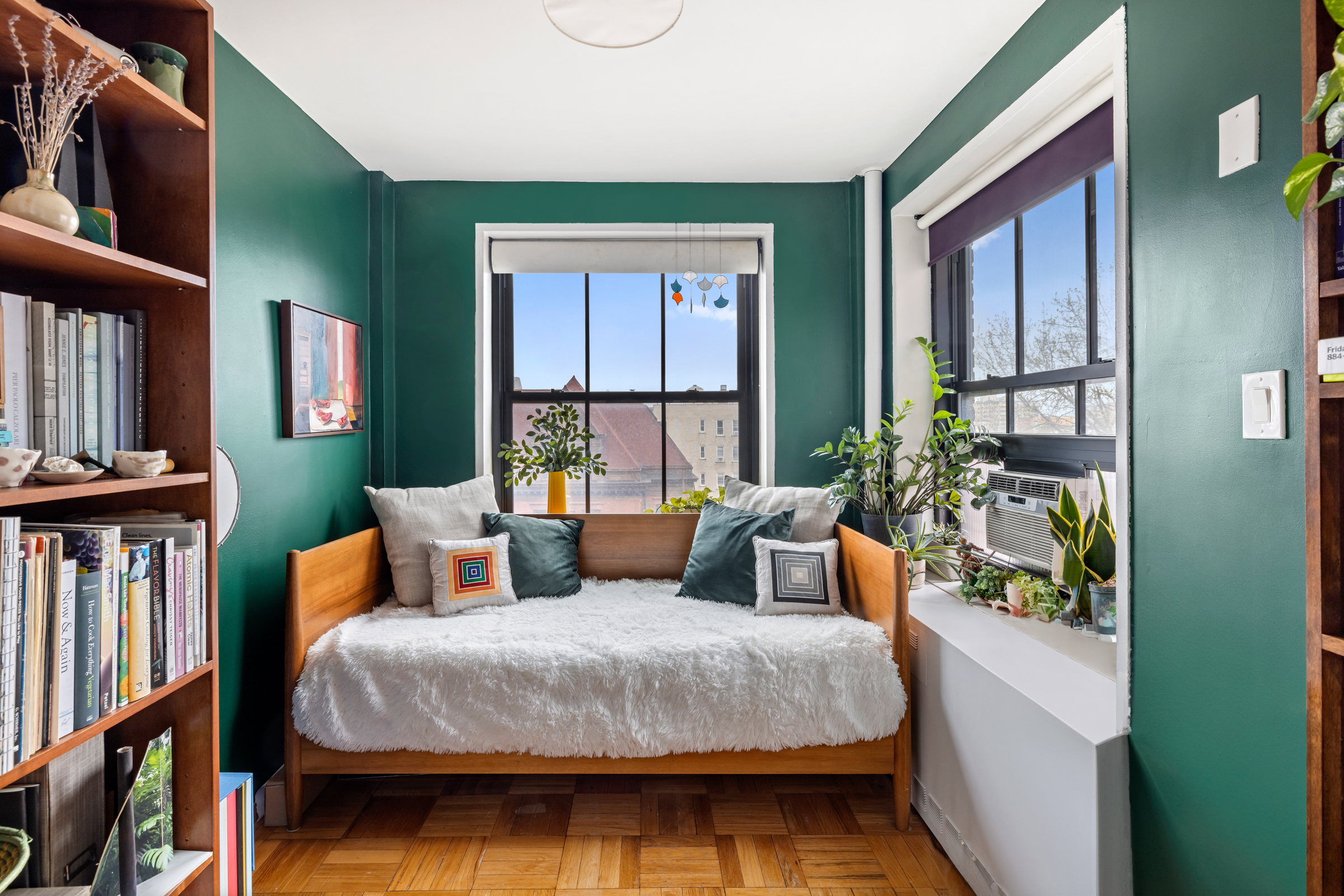325 Clinton Avenue, Unit 7A Brooklyn, NY 11205 - Photo 8 of 13 a bedroom with a bed a bookshelf and a window