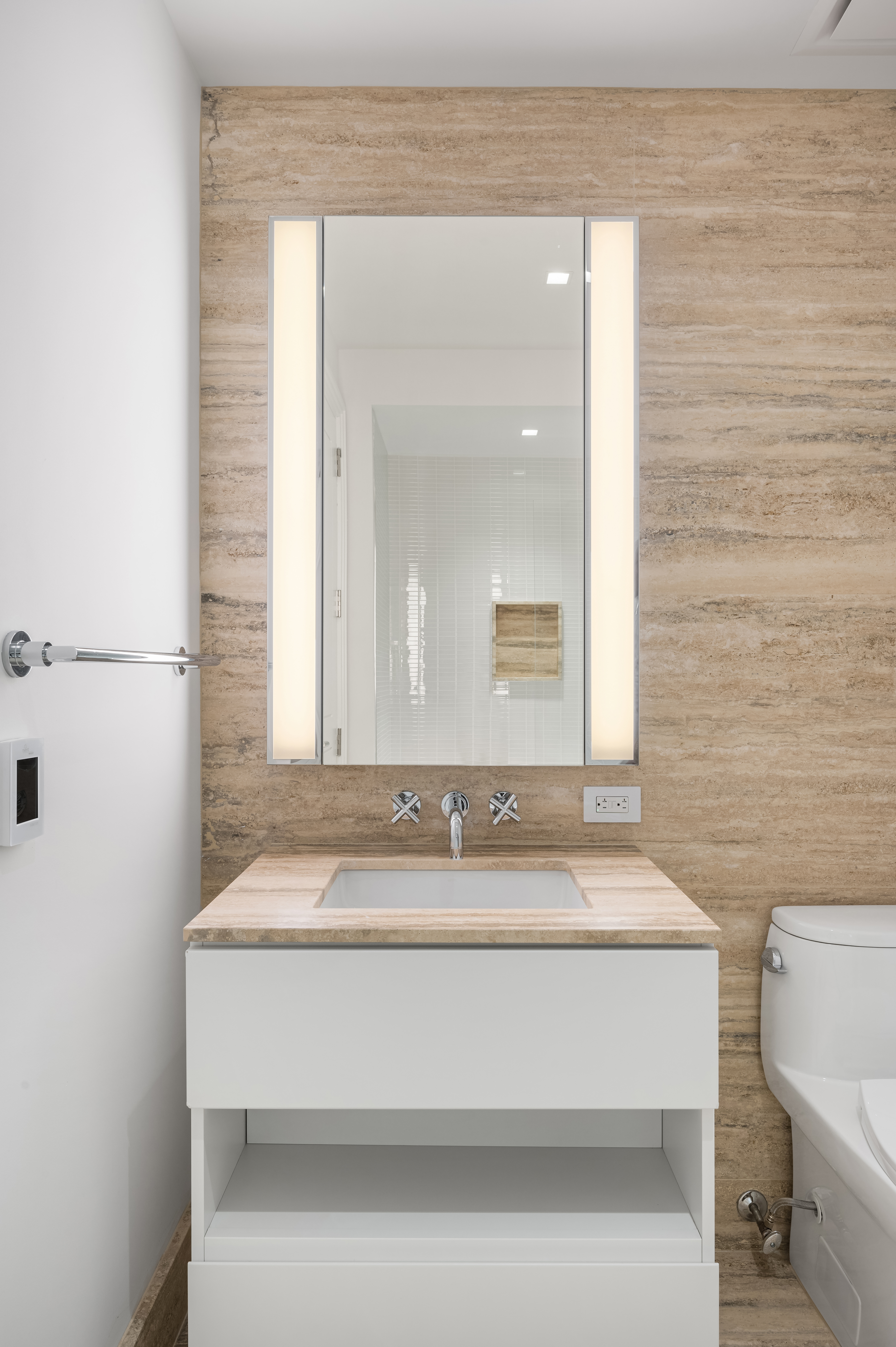 1 Wall Street, Unit 915 Manhattan, NY 10005 - Photo 7 of 18 a bathroom with a sink and a mirror