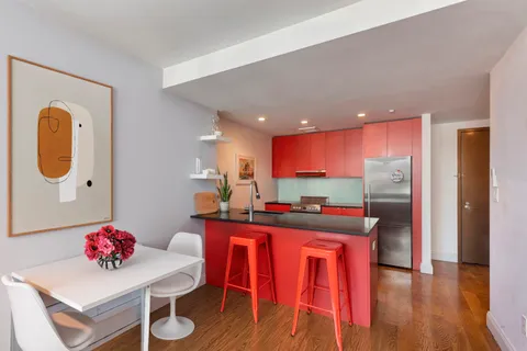 a kitchen with a table and chairs