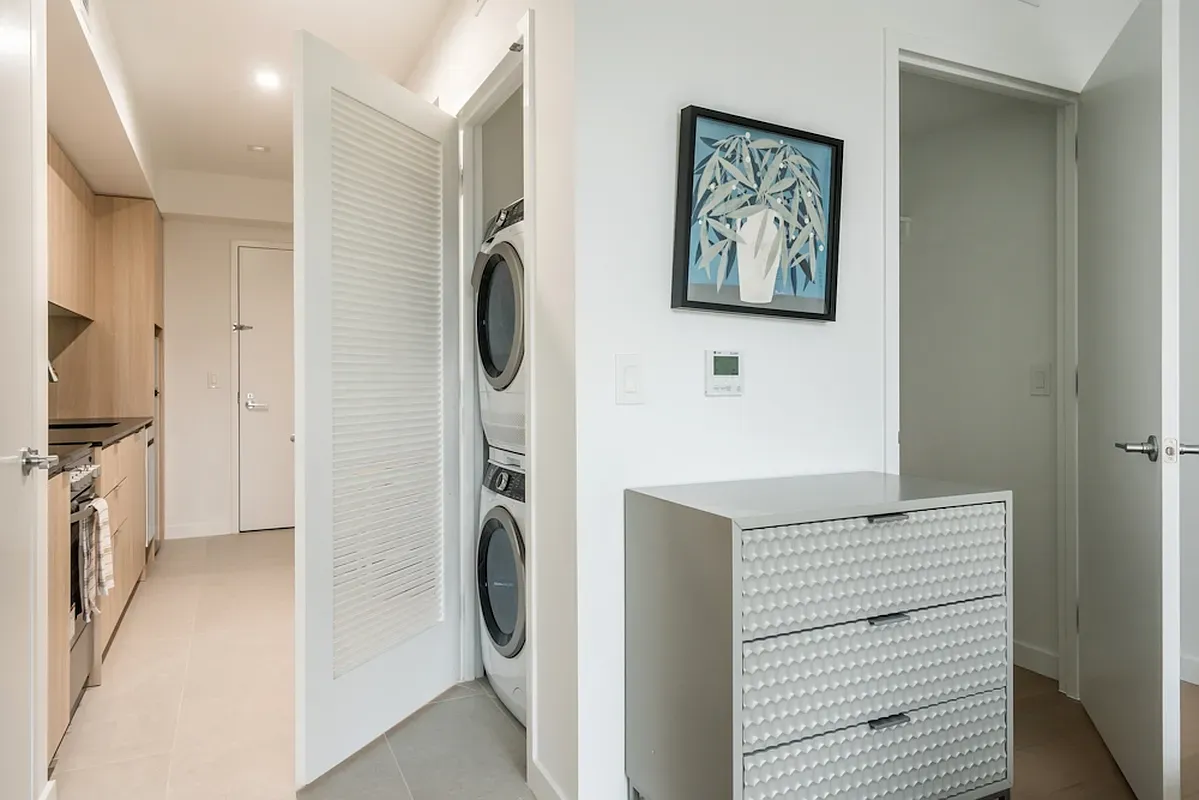 a view of a hallway with washer and dryer
