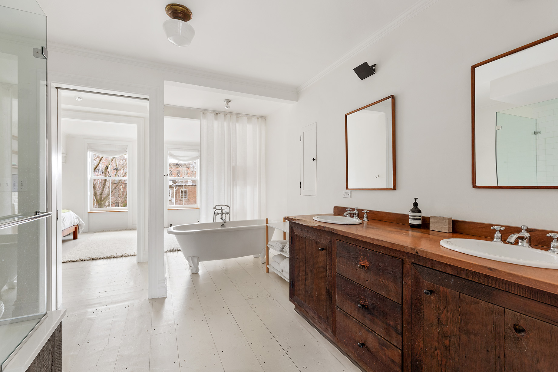 246 Bergen Street Brooklyn, NY 11217 - Photo 13 of 20 a spacious bathroom with a tub sink and mirror