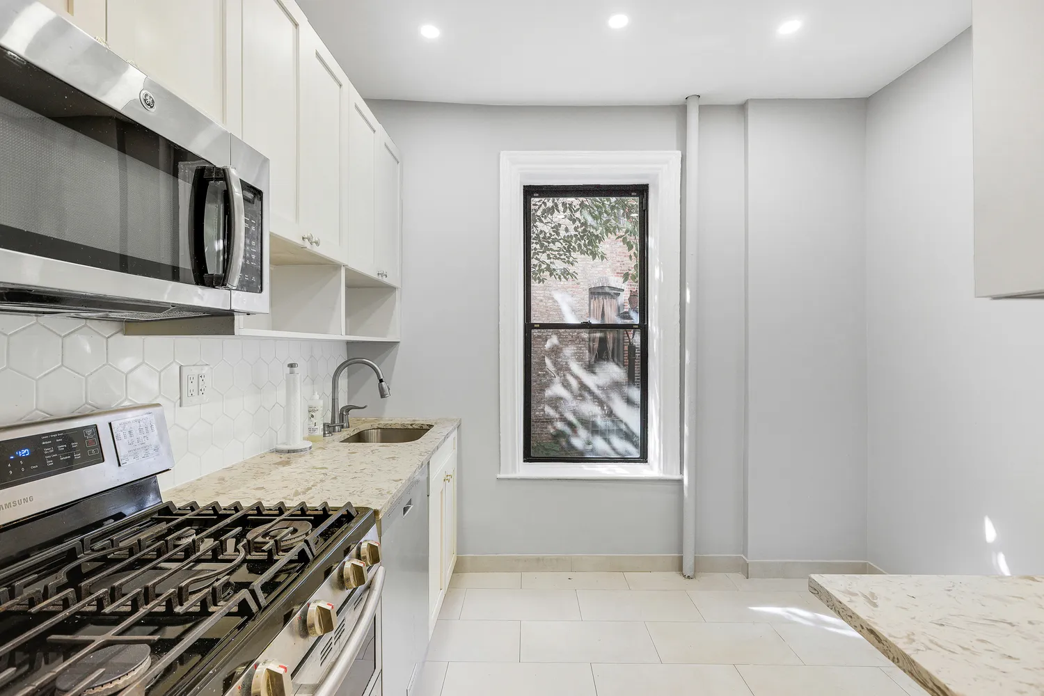 a kitchen with a stove and a microwave