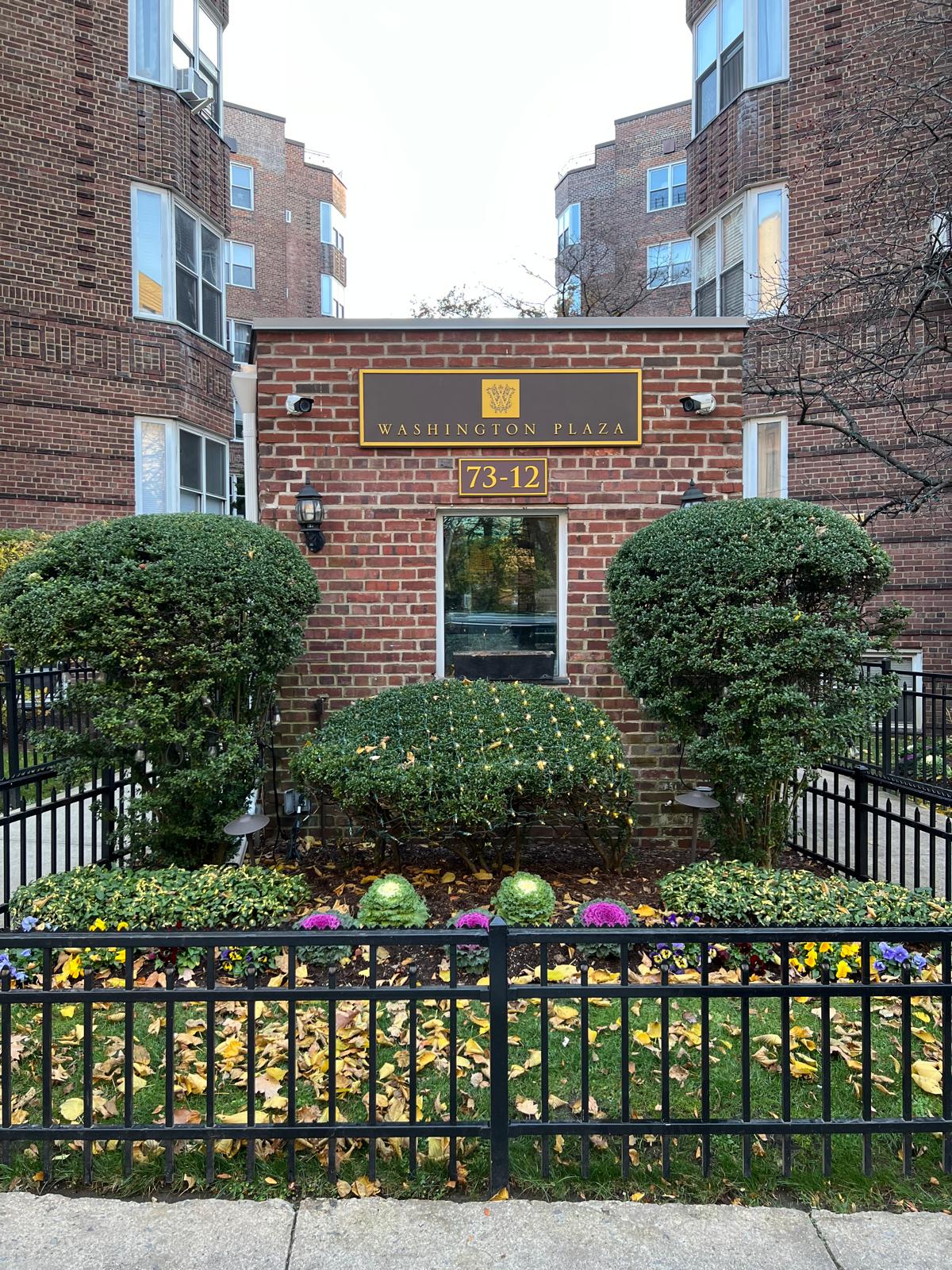 73-12 35th Avenue, Unit D56 Queens, NY 11372 - Photo 11 of 15 a front view of a house with a yard