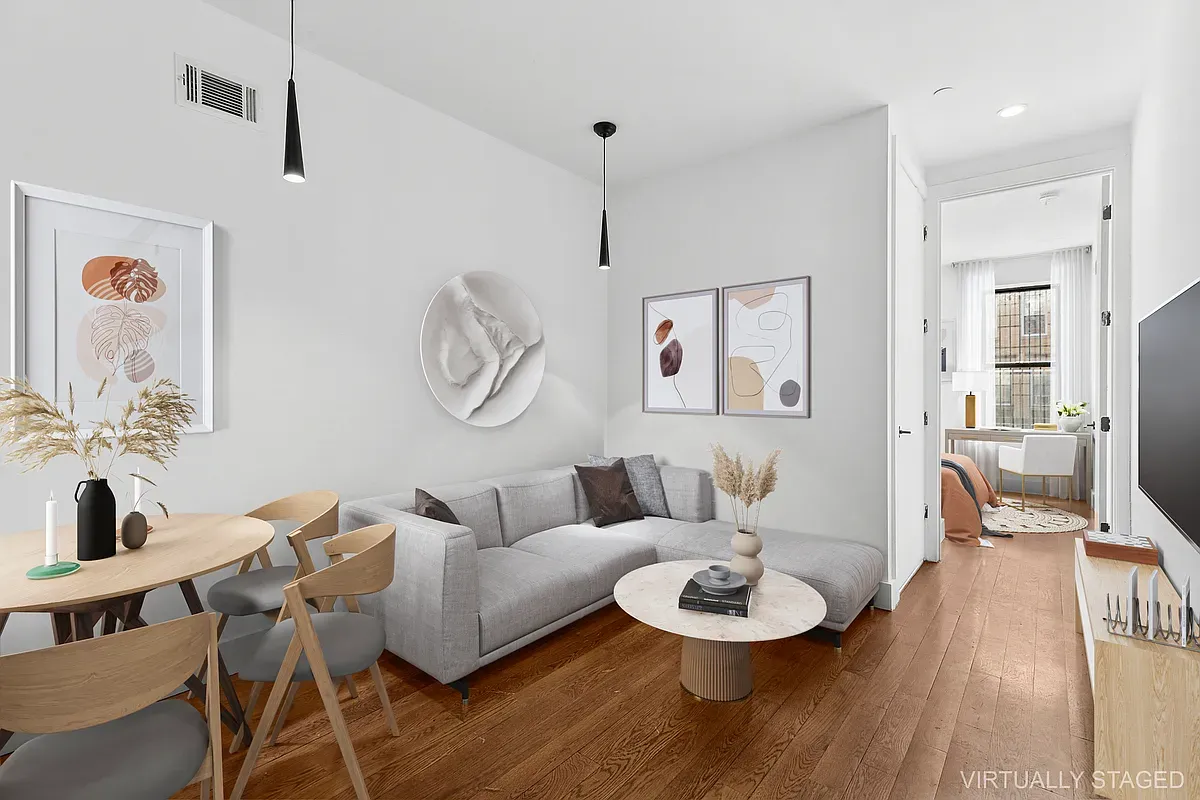 a living room with furniture a rug and a wall painting