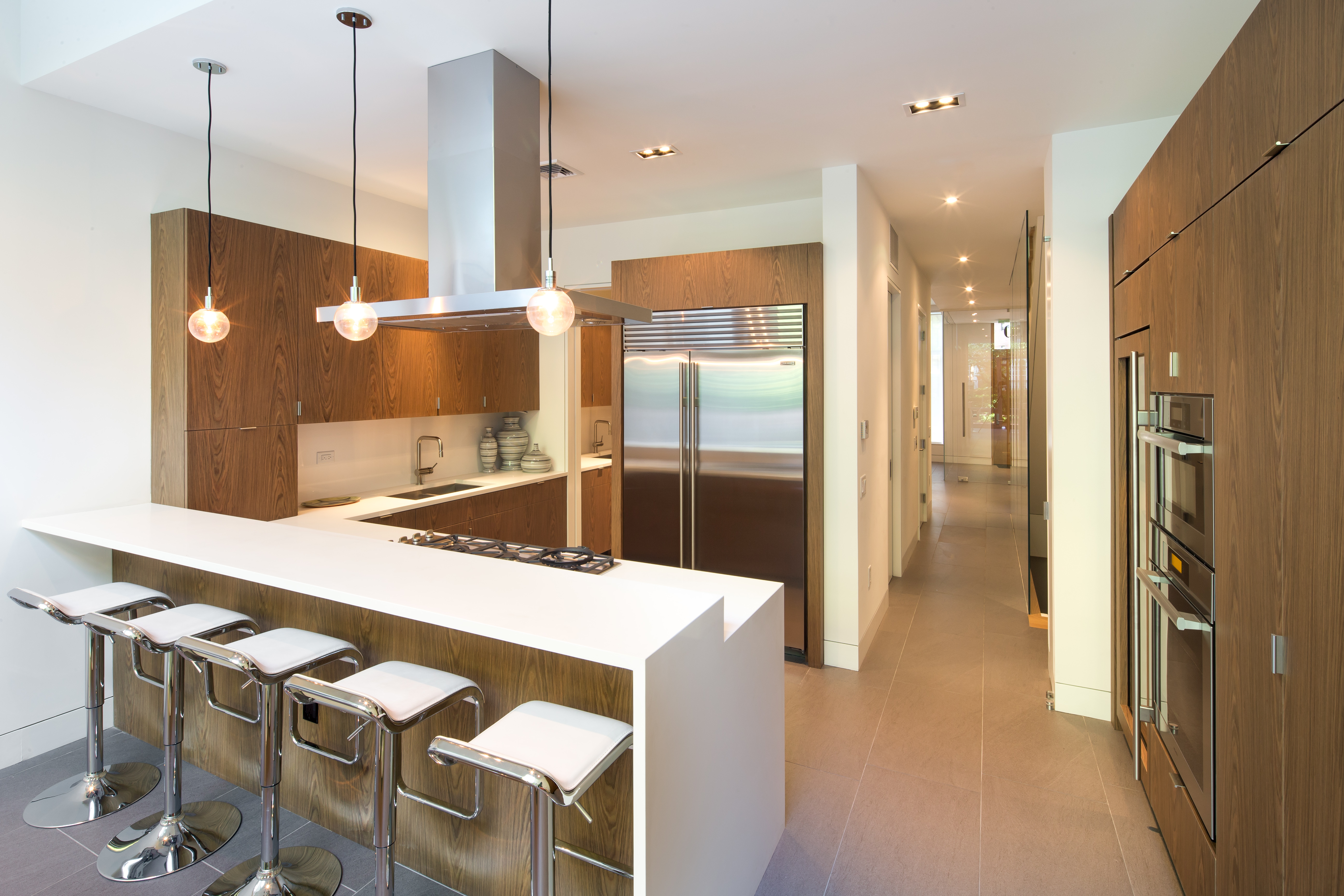 450 West 25th Street Manhattan, NY 10001 - Photo 6 of 16 a kitchen with stainless steel appliances kitchen island granite countertop a refrigerator a stove and a sink