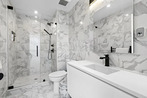 a living room with furniture a rug and a flat screen tv