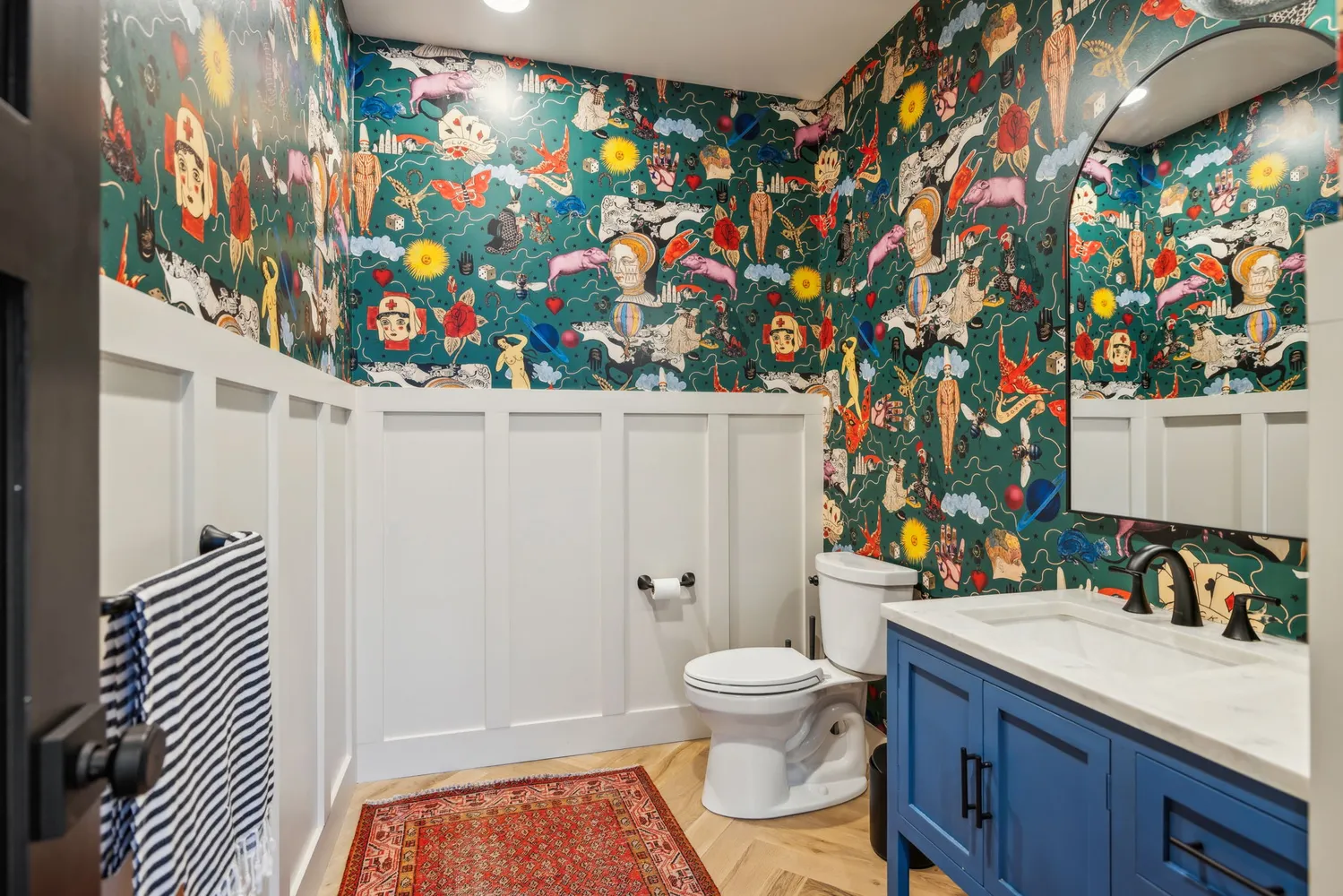 a bathroom with a sink mirror vanity and toilet