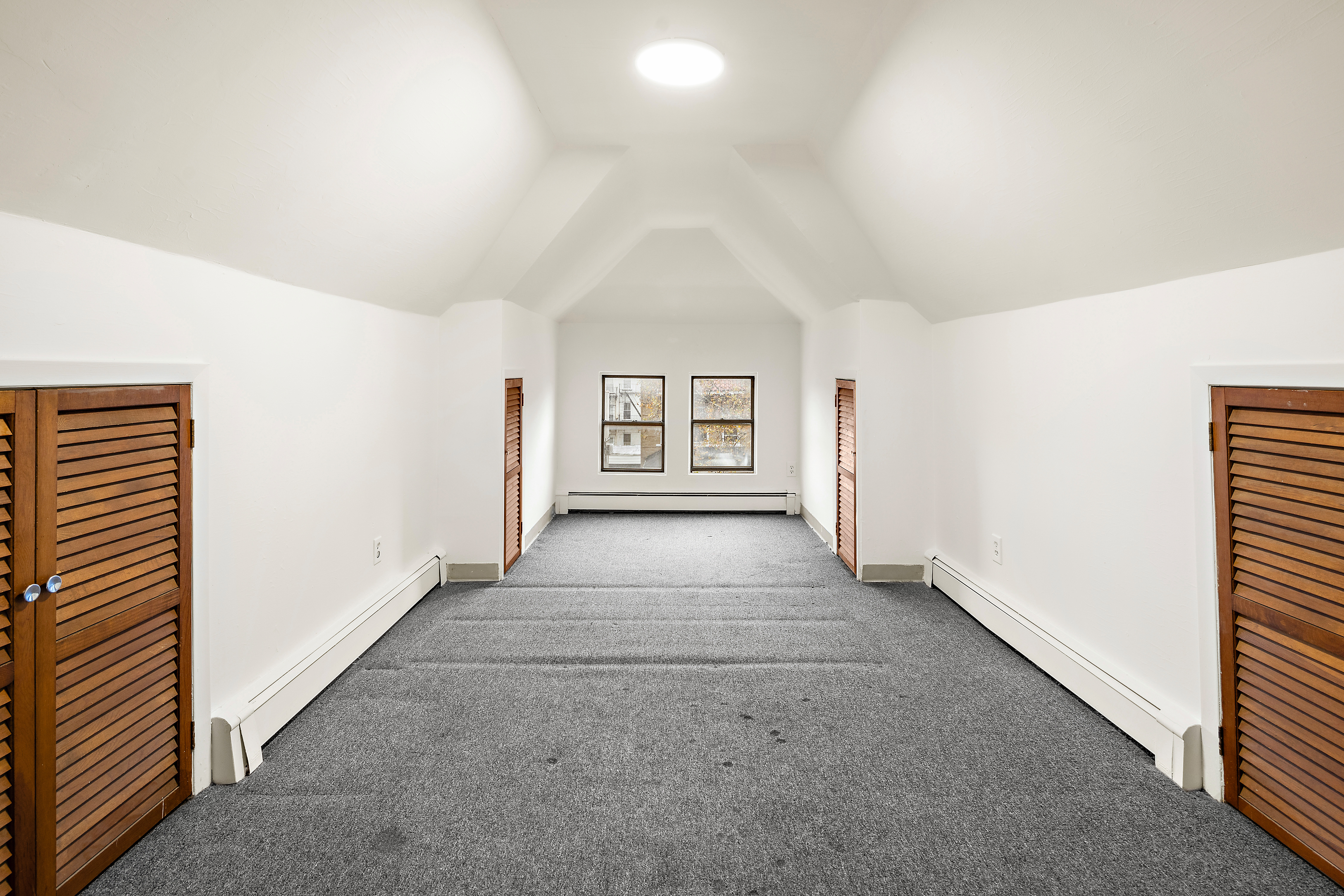 562 84th Street Brooklyn, NY 11209 - Photo 18 of 25 an empty room with windows and cabinet