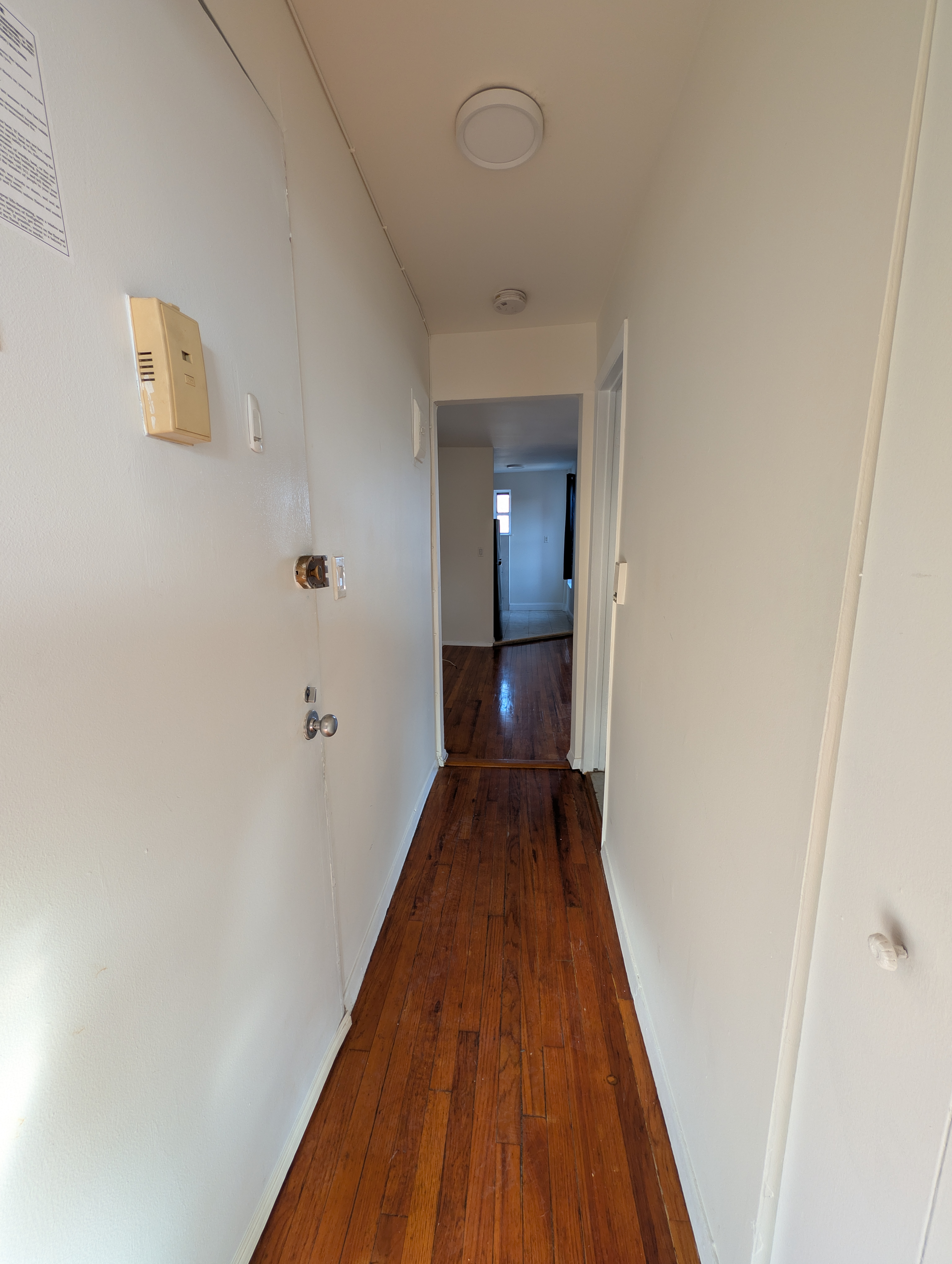 443 Hicks Street, Unit 6H Brooklyn, NY 11201 - Photo 9 of 11 a view of a hallway with wooden floor and staircase