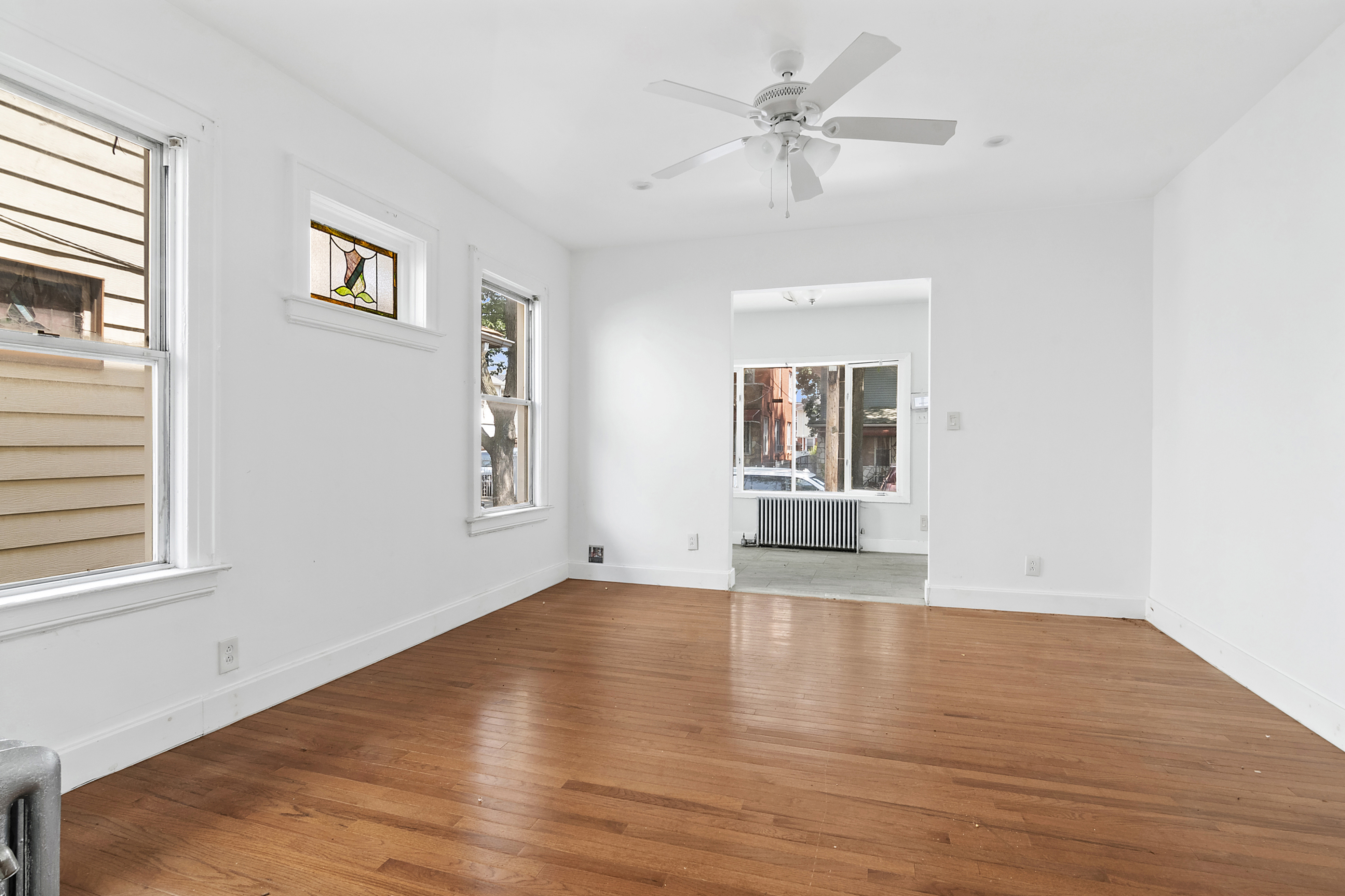 266 East 43rd Street Brooklyn, NY 11203 - Photo 4 of 11 a view of empty room with wooden floor and fan