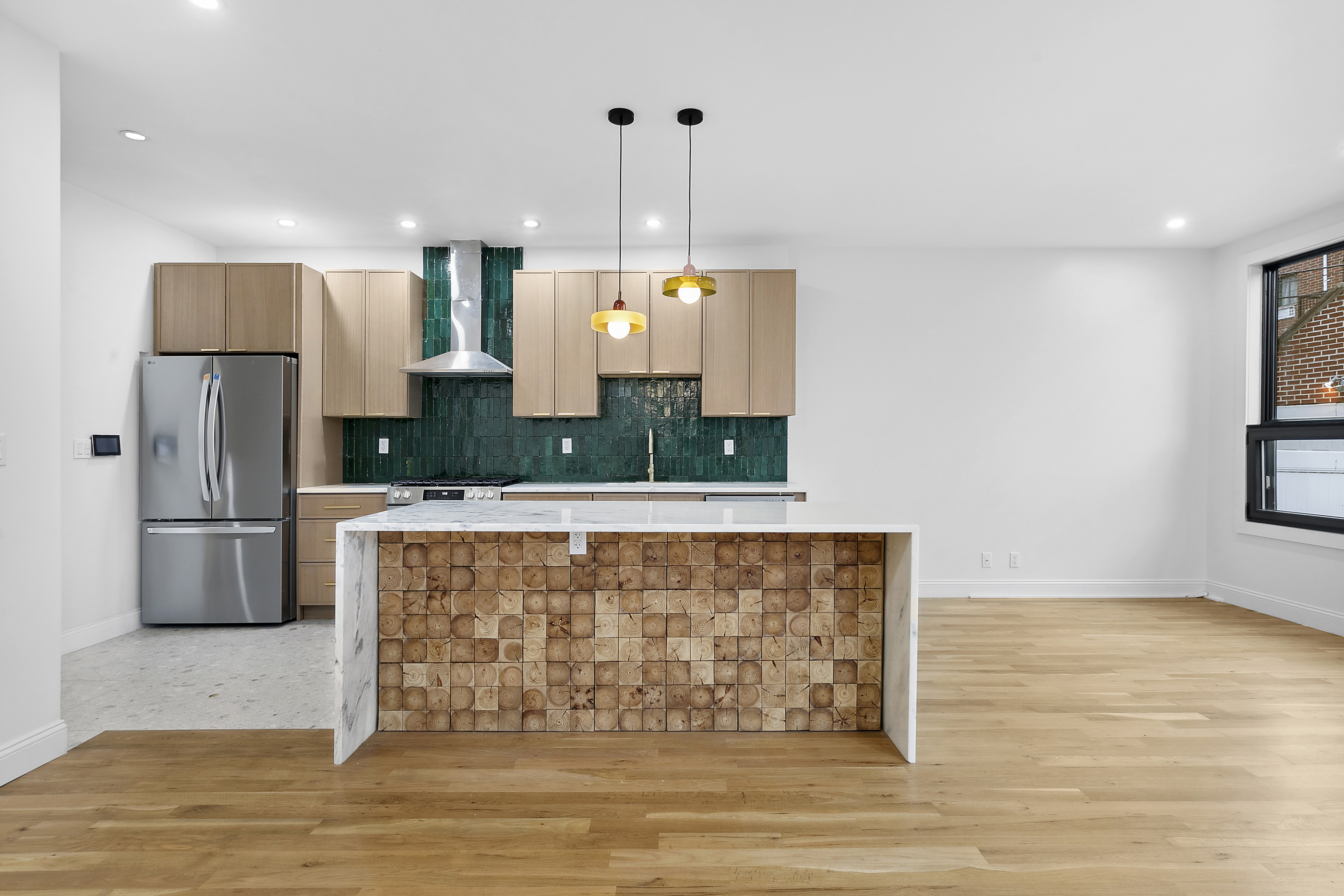 35-17 30th Street, Unit GARDEN Queens, NY 11106 - Photo 10 of 14 a view of kitchen island wooden floor cabinets and appliances