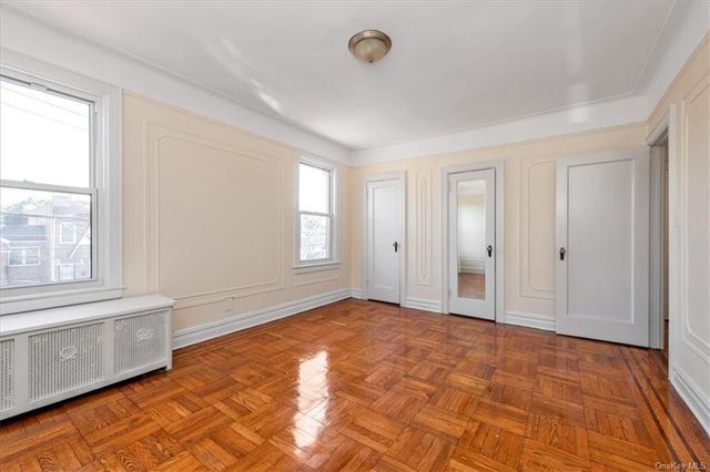 1186 Brooklyn Avenue, Unit N A Brooklyn, NY 11203 - Photo 11 of 17 a view of an empty room with window and wooden floor