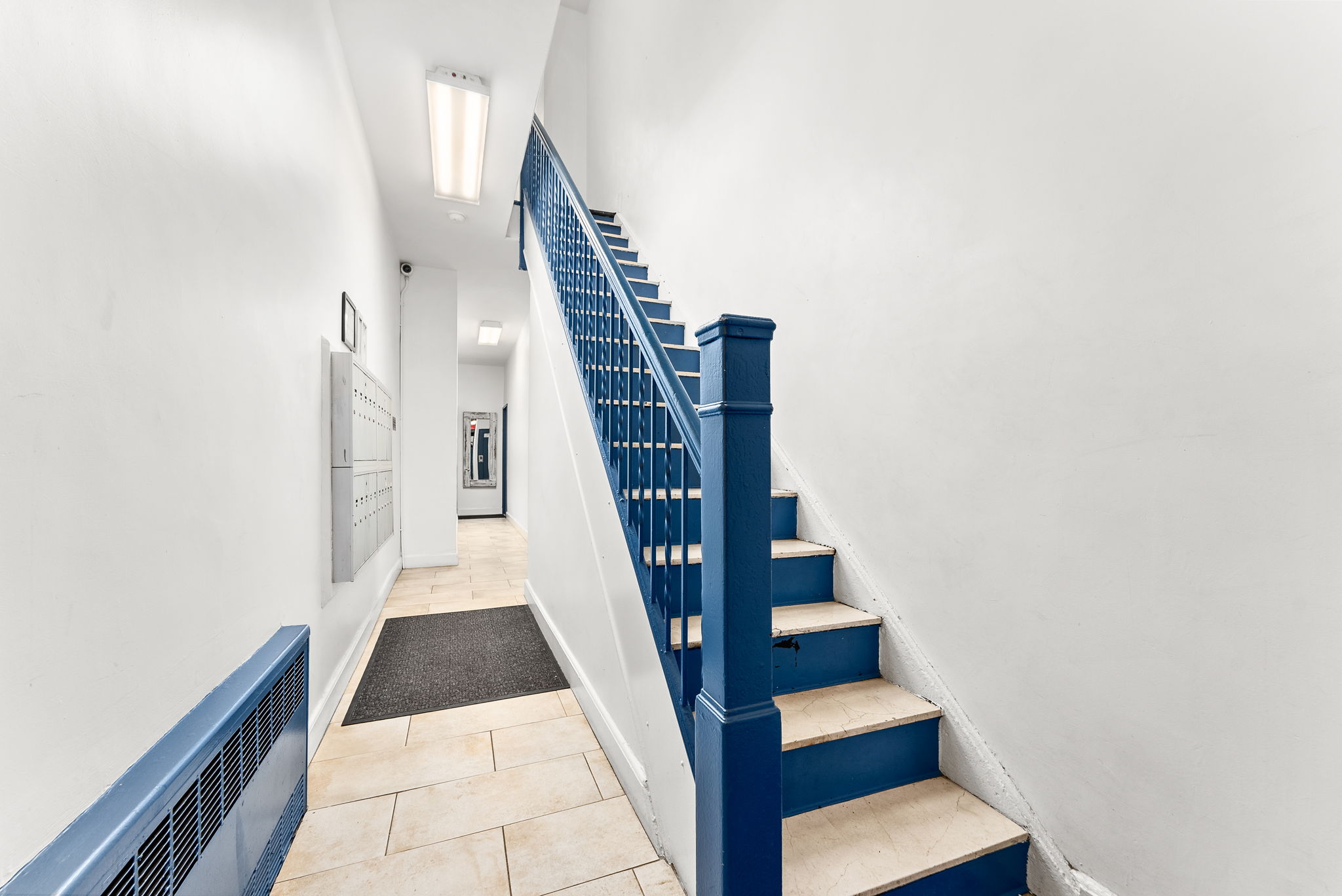 512 East 83rd Street, Unit D4 Manhattan, NY 10028 - Photo 18 of 21 a view of staircase with white walls and railing