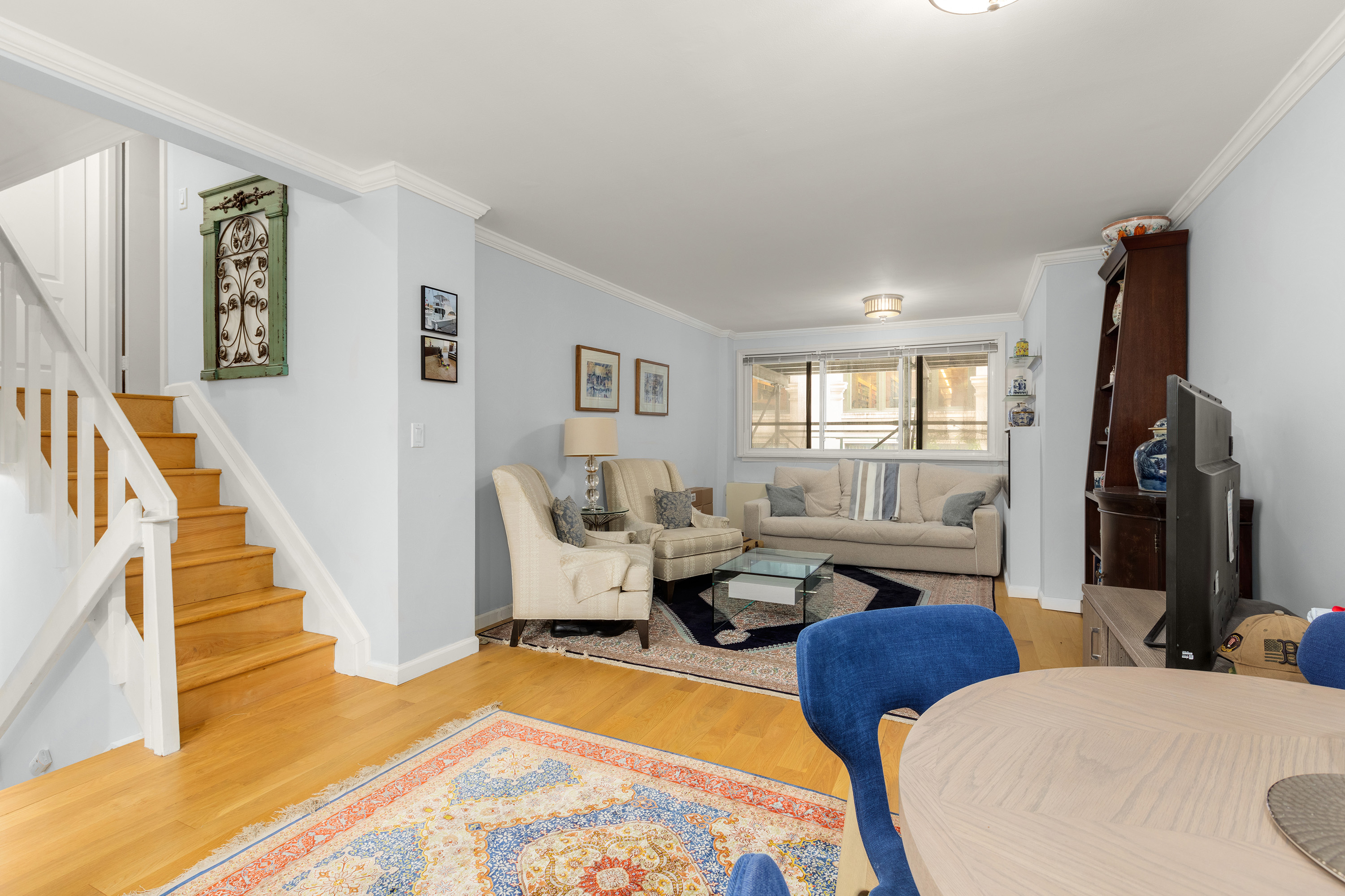 7 East 35th Street, Unit 2E Manhattan, NY 10016 - Photo 2 of 10 a living room with furniture fireplace and a flat screen tv