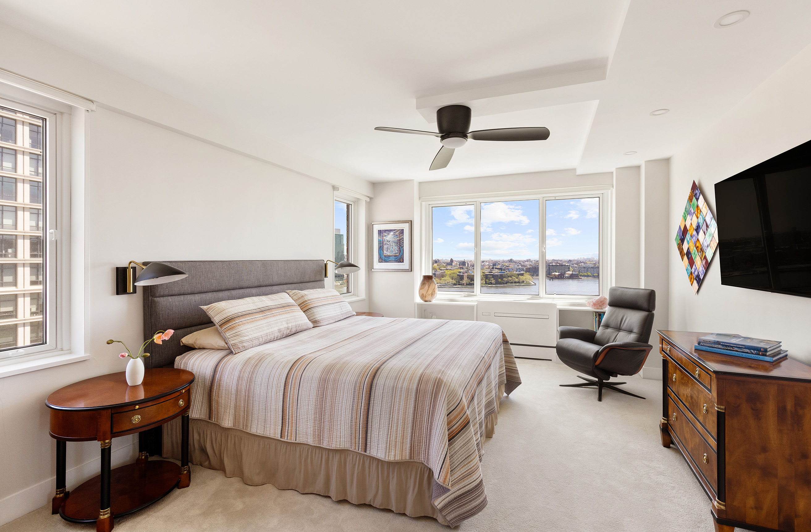 535 East 86th Street, Unit 16F Manhattan, NY 10028 - Photo 9 of 19 a bedroom with a bed and a couch
