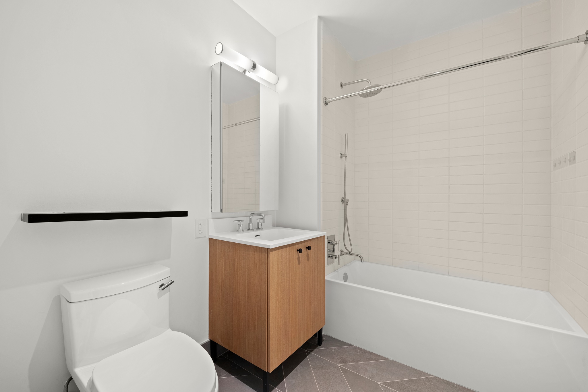 160 Front Street, Unit 706 Brooklyn, NY 11201 - Photo 14 of 17 a bathroom with a granite countertop sink toilet and shower