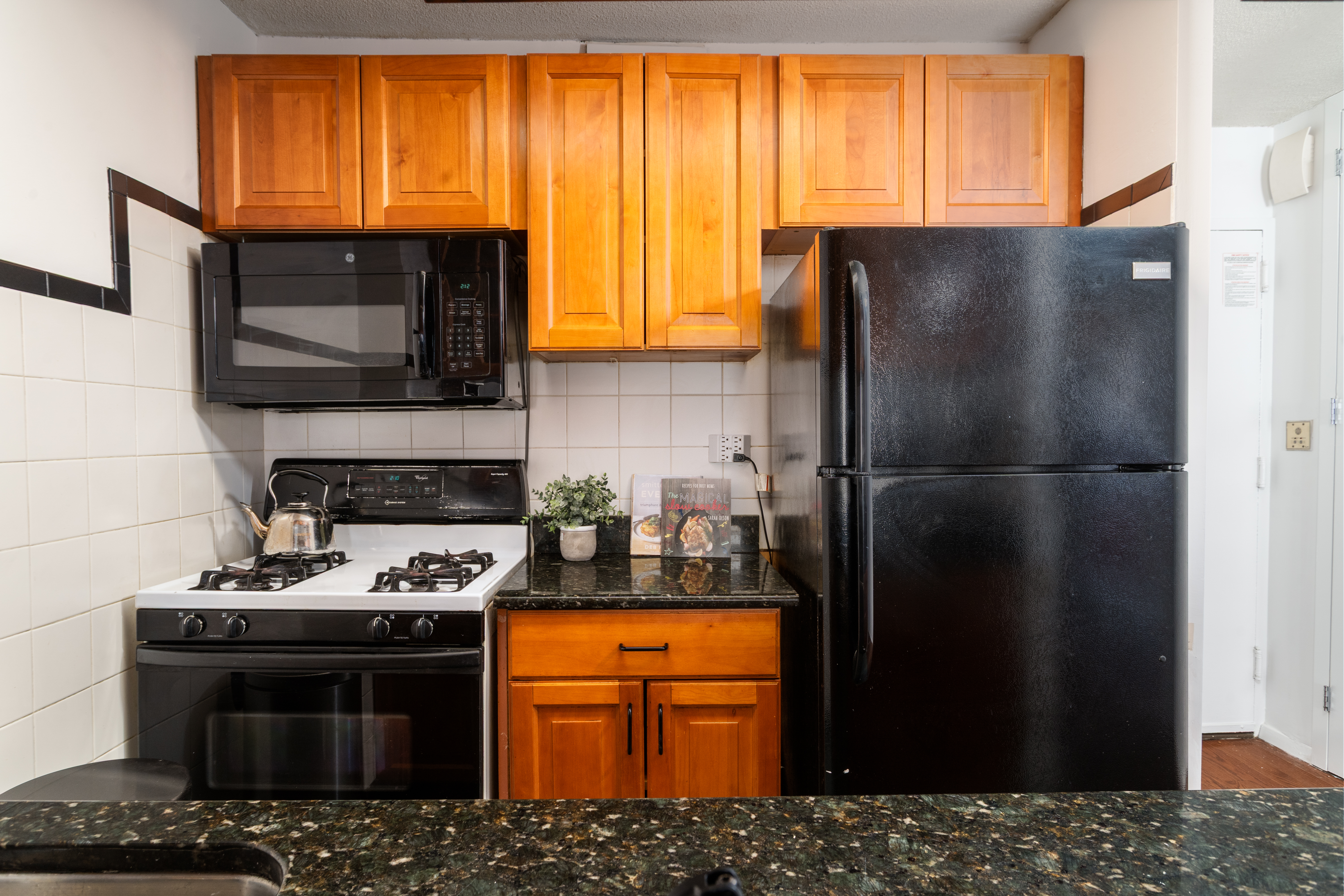 275 West 96th Street, Unit 12B Manhattan, NY 10025 - Photo 6 of 28 a kitchen with stainless steel appliances granite countertop a refrigerator stove and microwave