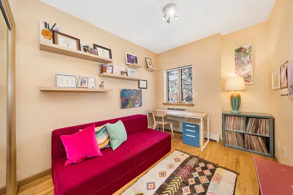 a living room with furniture and a book shelf