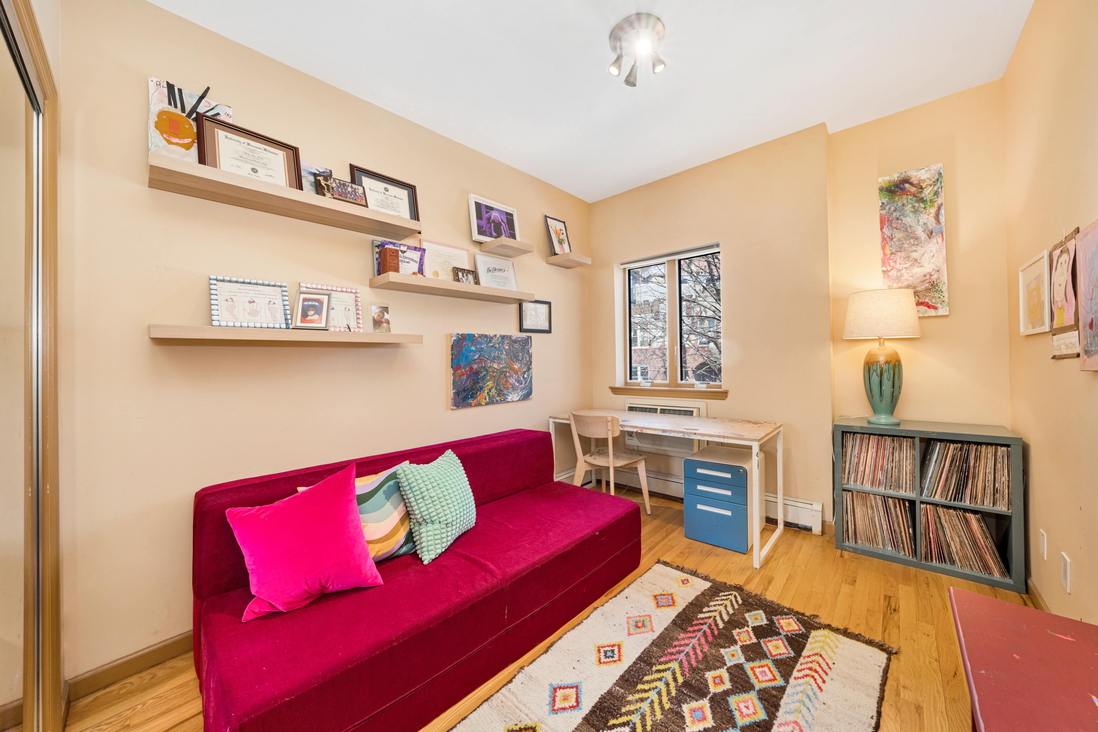 2356 61st Street, Unit 1B Brooklyn, NY 11204 - Photo 7 of 10 a living room with furniture and a book shelf