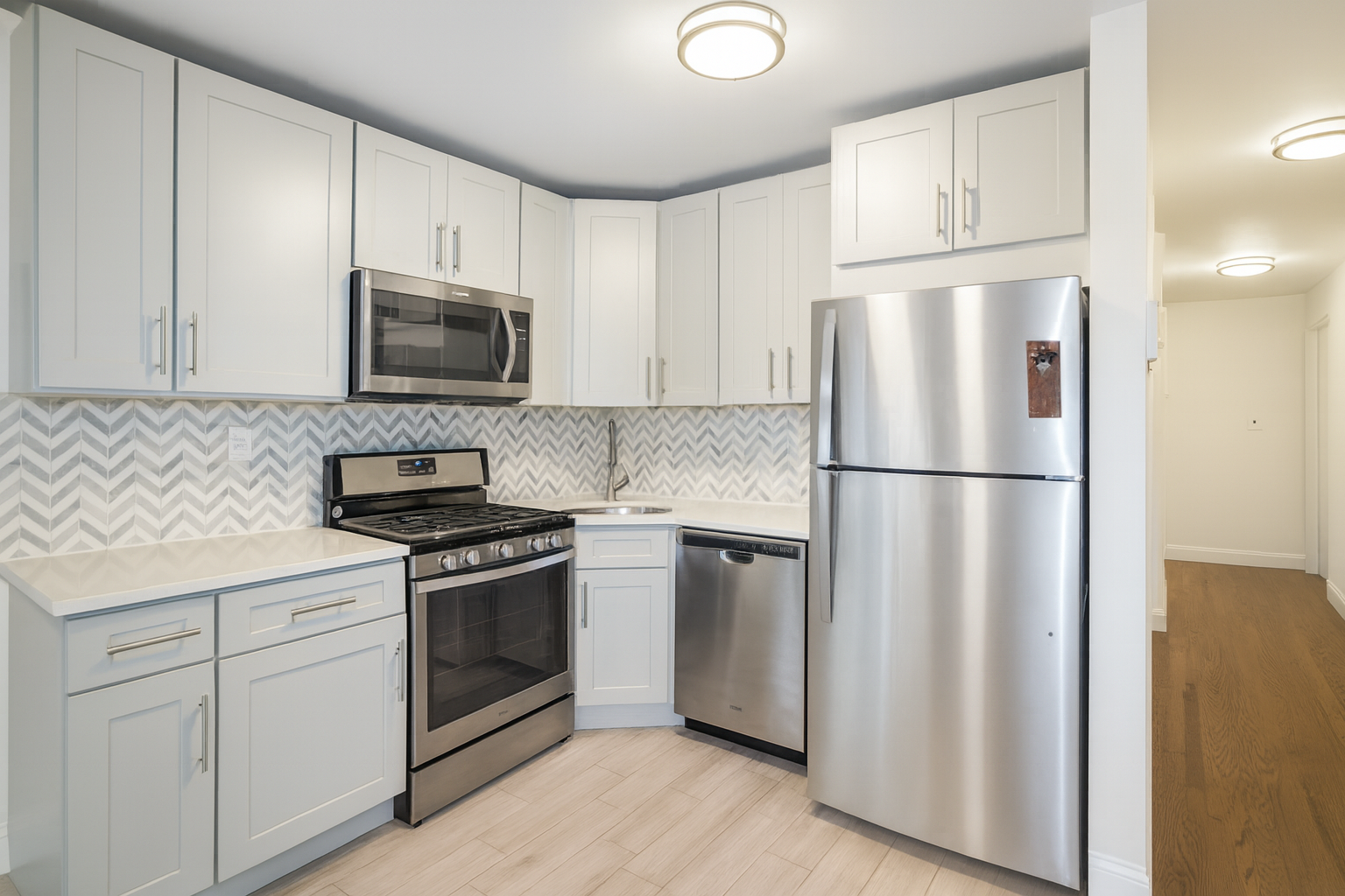 187 Woodpoint Road Brooklyn, NY 11211 - Photo 3 of 17 a kitchen with cabinets stainless steel appliances and wooden cabinets
