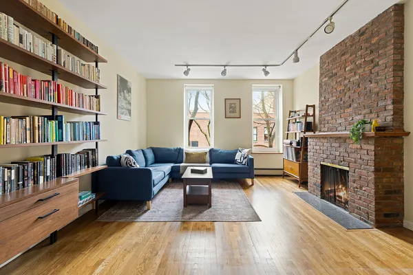 a living room with furniture and a fireplace