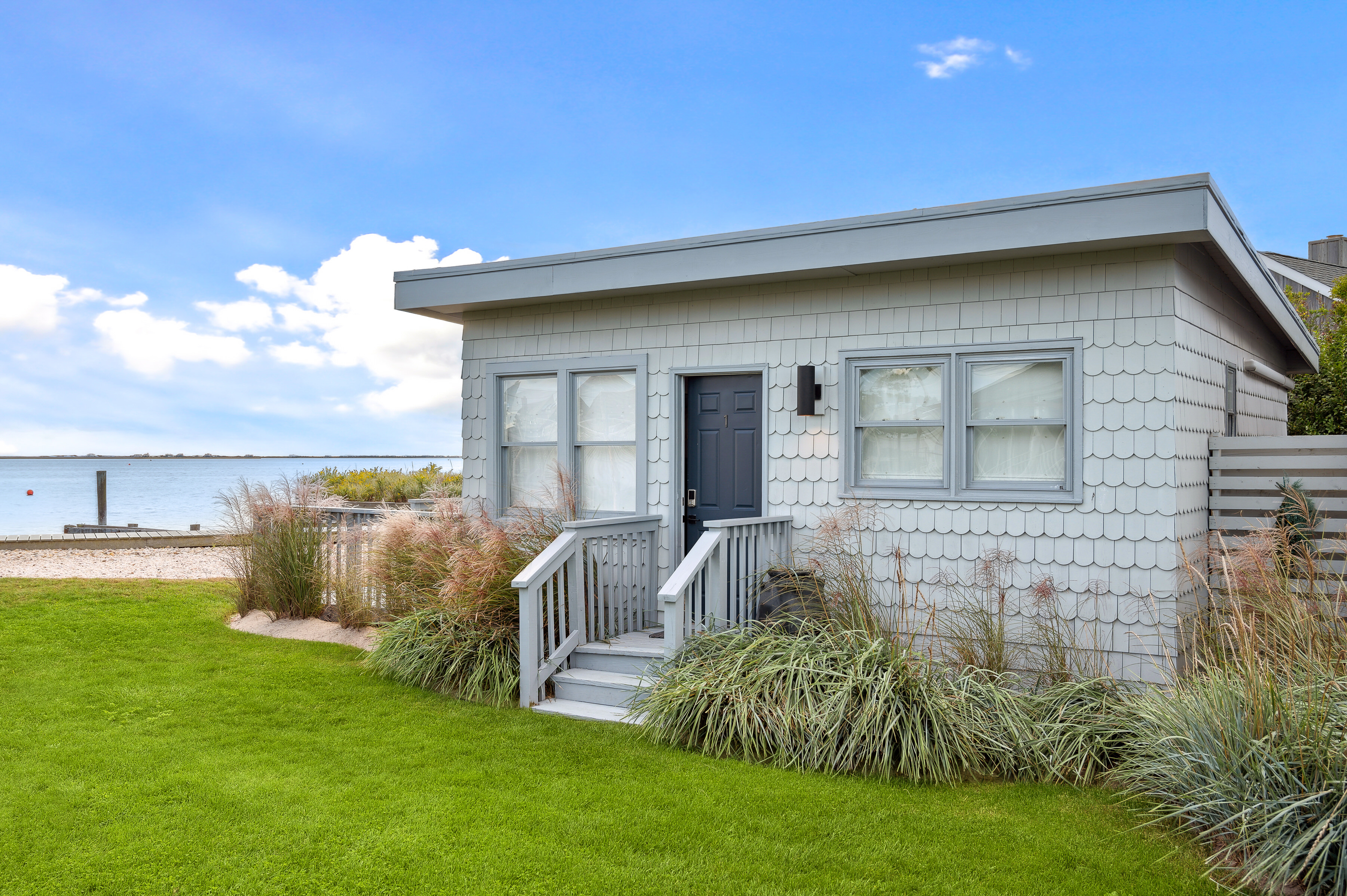 32 Lighthouse Road Hampton Bays, NY 11946 - Photo 35 of 51 a view of a house with a backyard