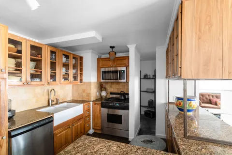 a kitchen with stainless steel appliances granite countertop a stove and a sink