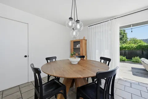 a view of a dining room with a table and chairs