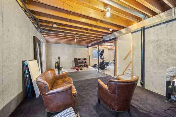 a living room with furniture a couch and a ceiling fan