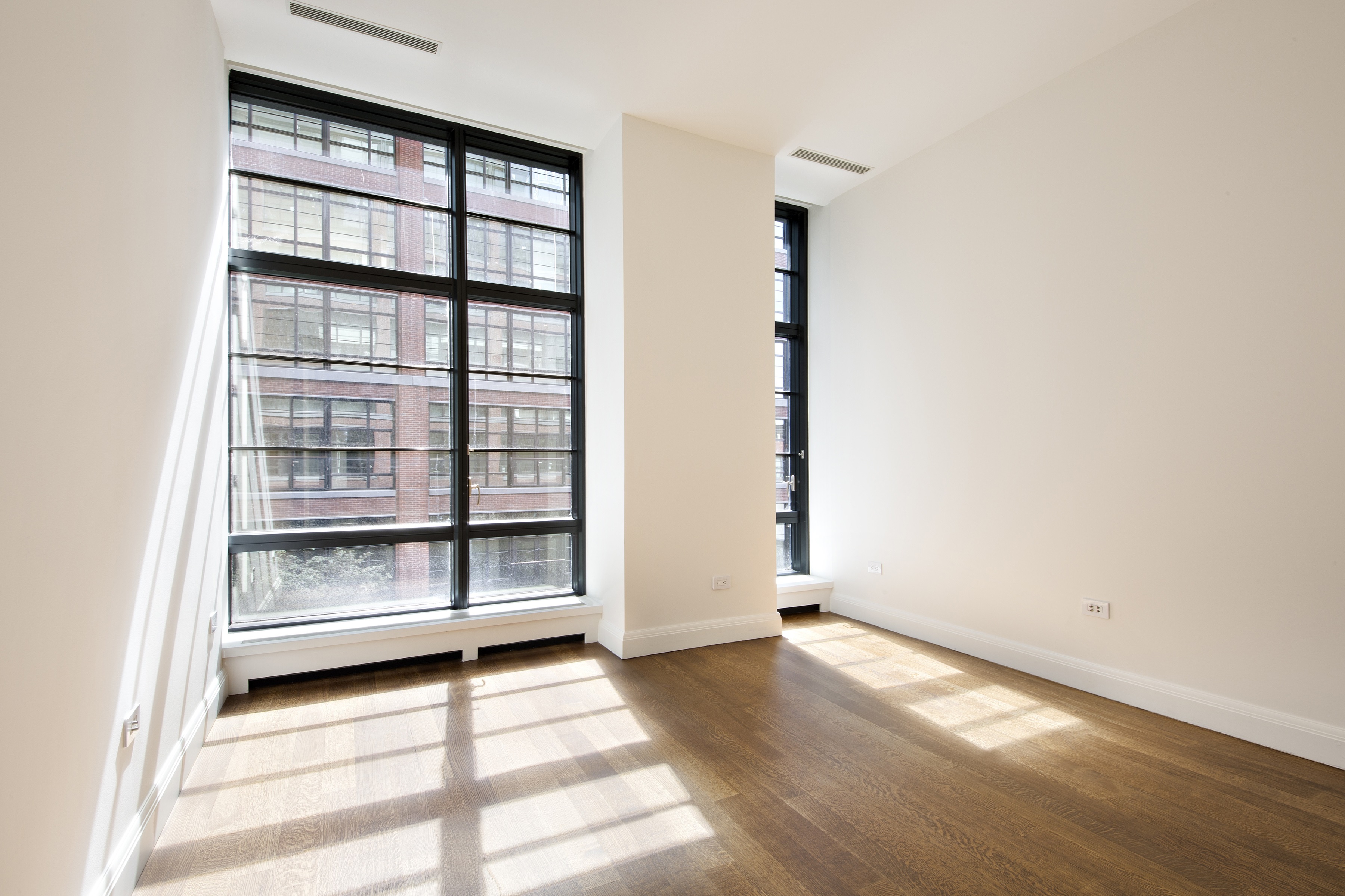 150 Charles Street, Unit 3BN Manhattan, NY 10014 - Photo 6 of 12 a view of an empty room with a window and wooden floor