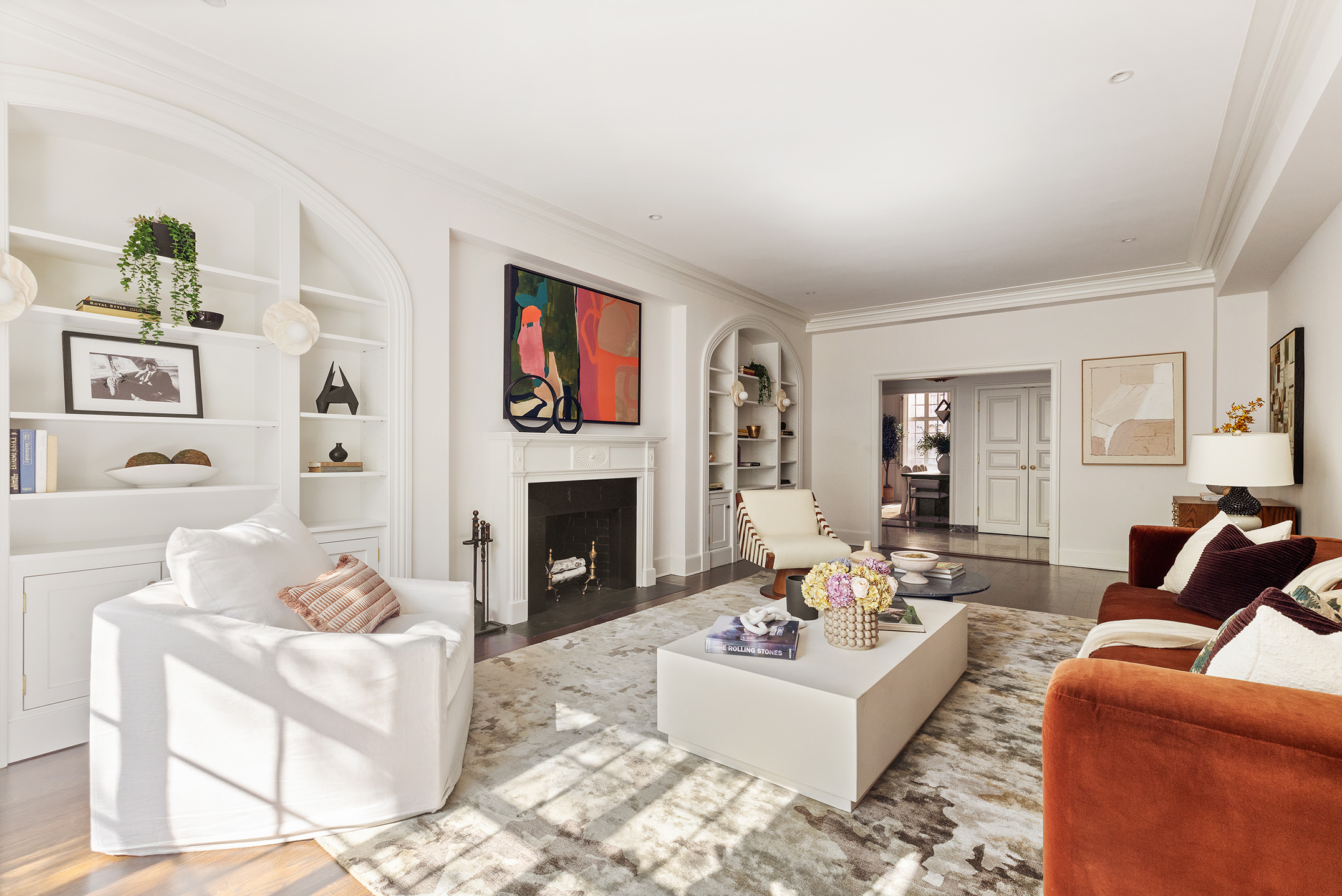 115 East 67th Street, Unit 3C Manhattan, NY 10065 - Photo 4 of 21 a living room with furniture a fireplace and a flat screen tv