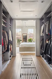 a view of walk in closet with clothes and shoes