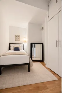 a bedroom with a bed and a night stand