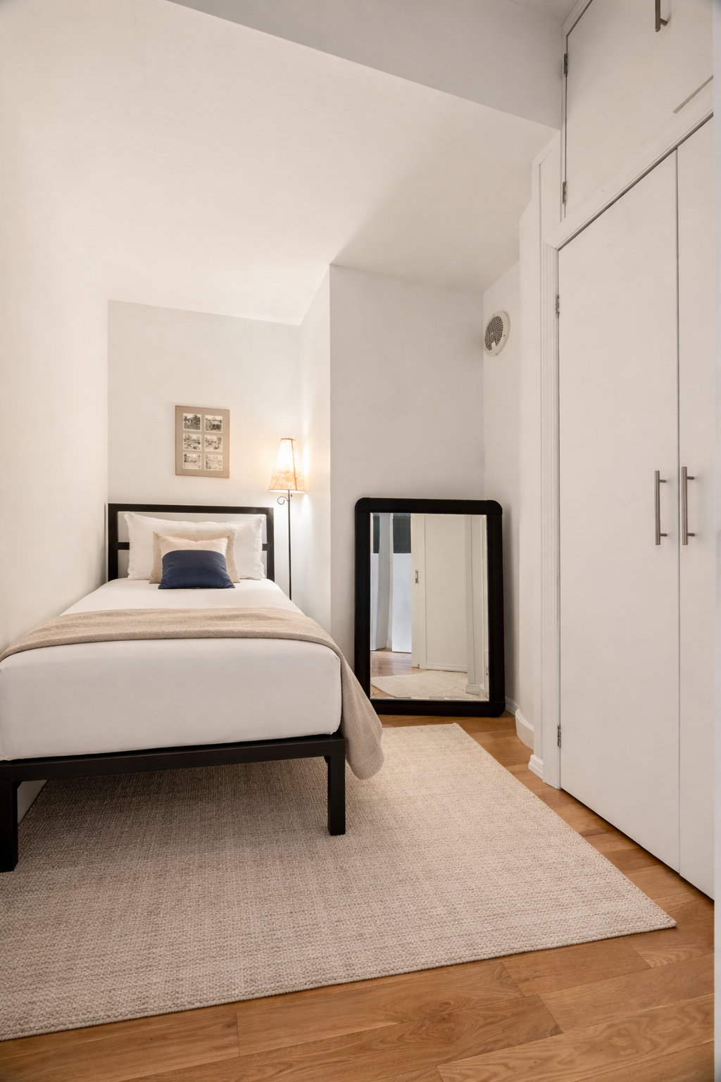 90 William Street, Unit 15F Manhattan, NY 10038 - Photo 5 of 10 a bedroom with a bed and a night stand