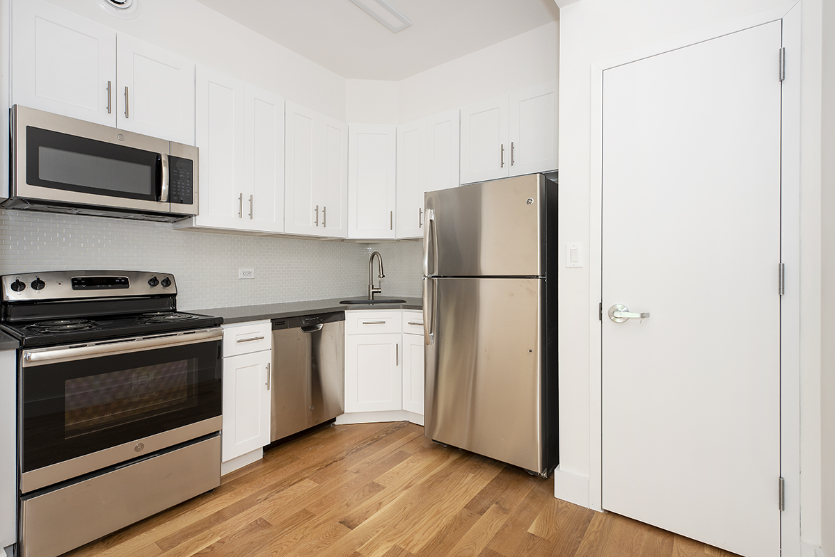216 Boerum Street, Unit 3B Brooklyn, NY 11206 - Photo 5 of 10 a kitchen with a refrigerator stove and microwave