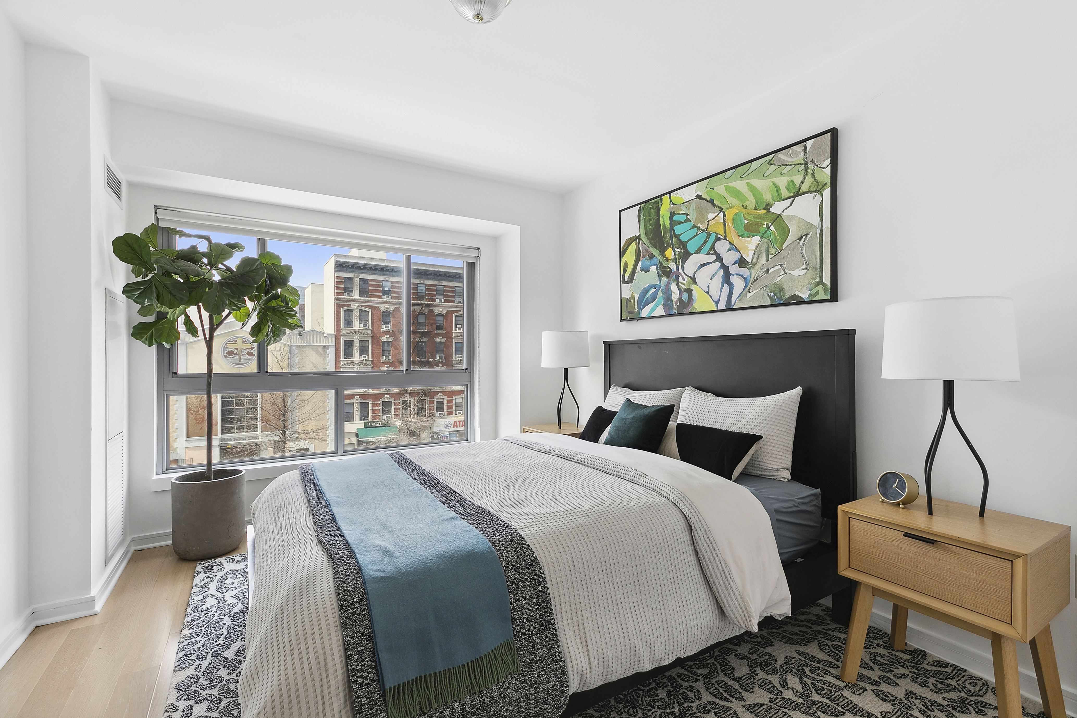 171 West 131st Street, Unit 407 Manhattan, NY 10027 - Photo 6 of 18 a bedroom with a bed and a window