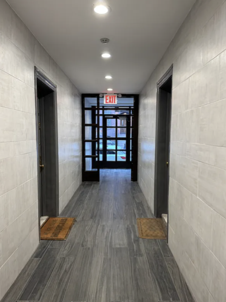 451 West 44th Street, Unit 63 Manhattan, NY 10036 - Photo 18 of 31 wooden floor in an empty room with a window