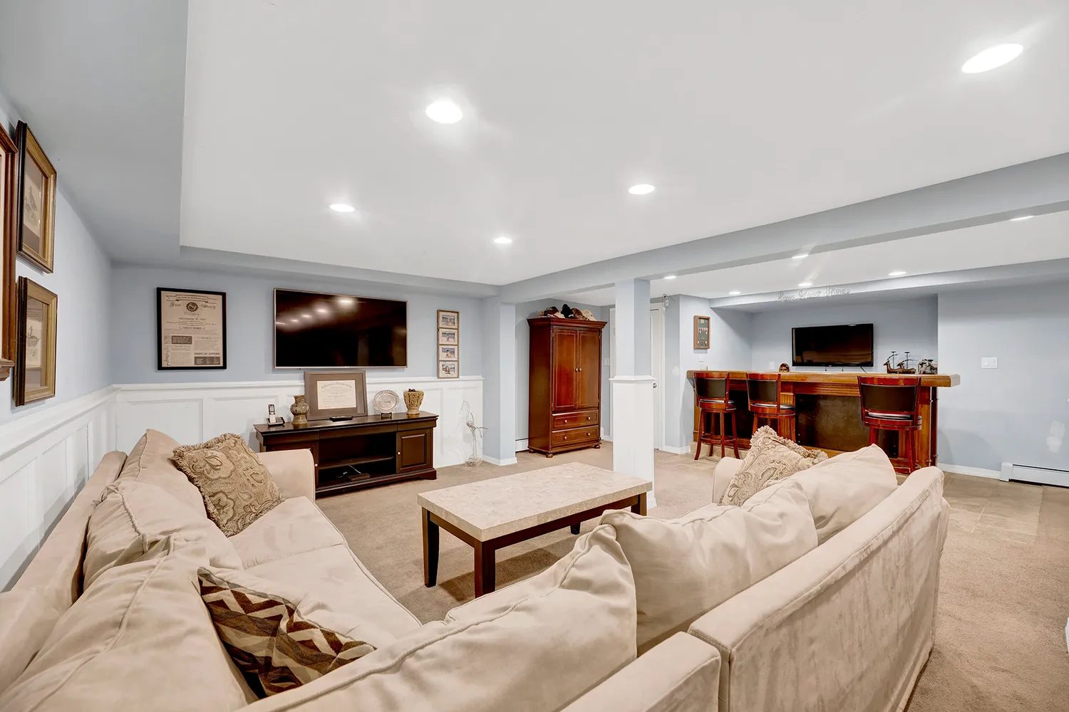 a front view of a house with garden and trees