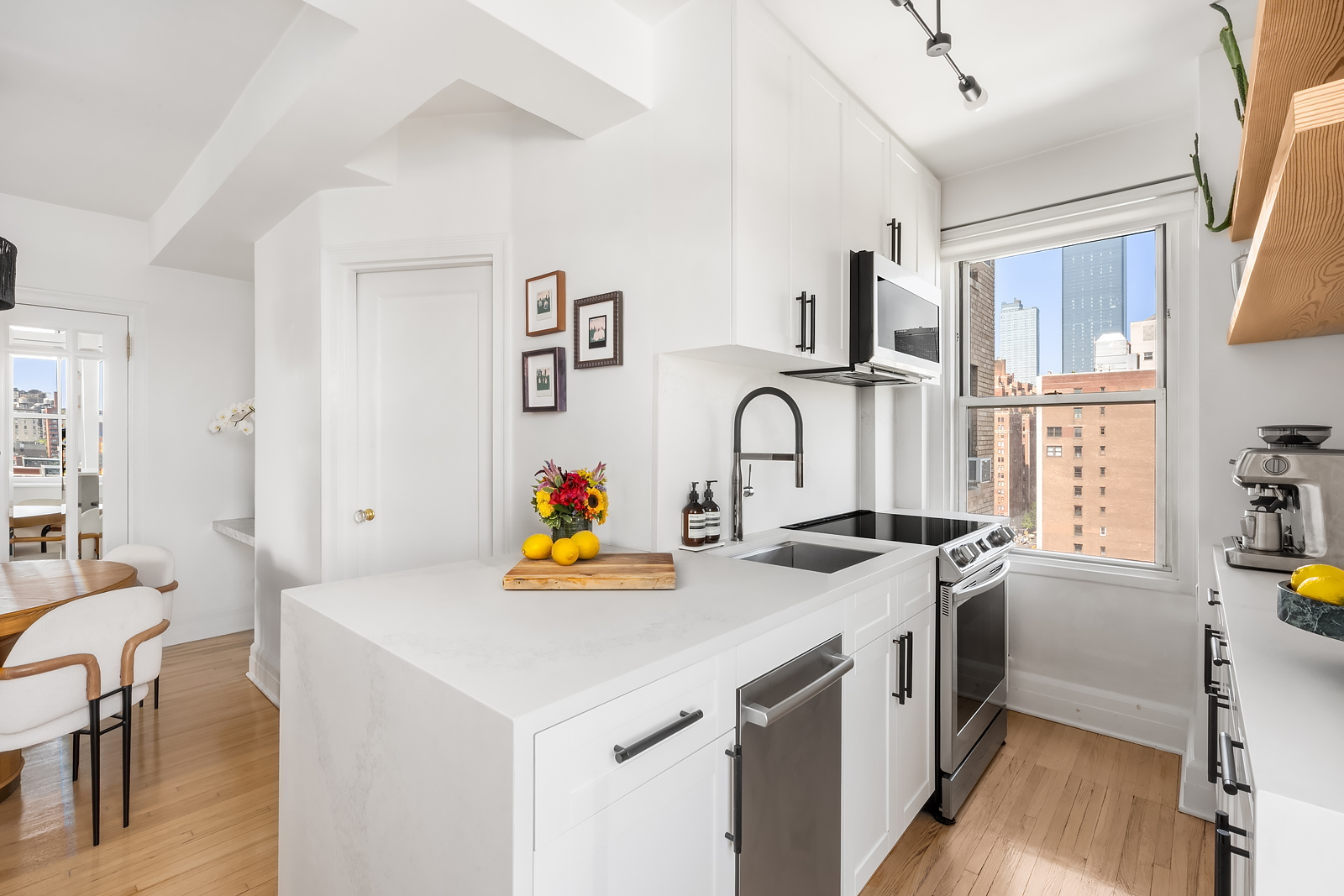 365 West 20th Street, Unit 14B Manhattan, NY 10011 - Photo 9 of 21 a view of a kitchen with a sink a stove and wooden floor