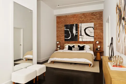 a bedroom with a bed and a table in it