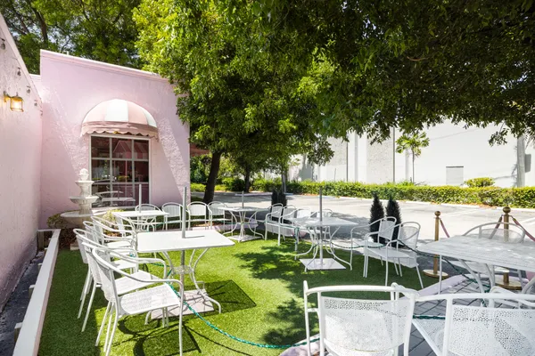 a view of backyard of house with seating area