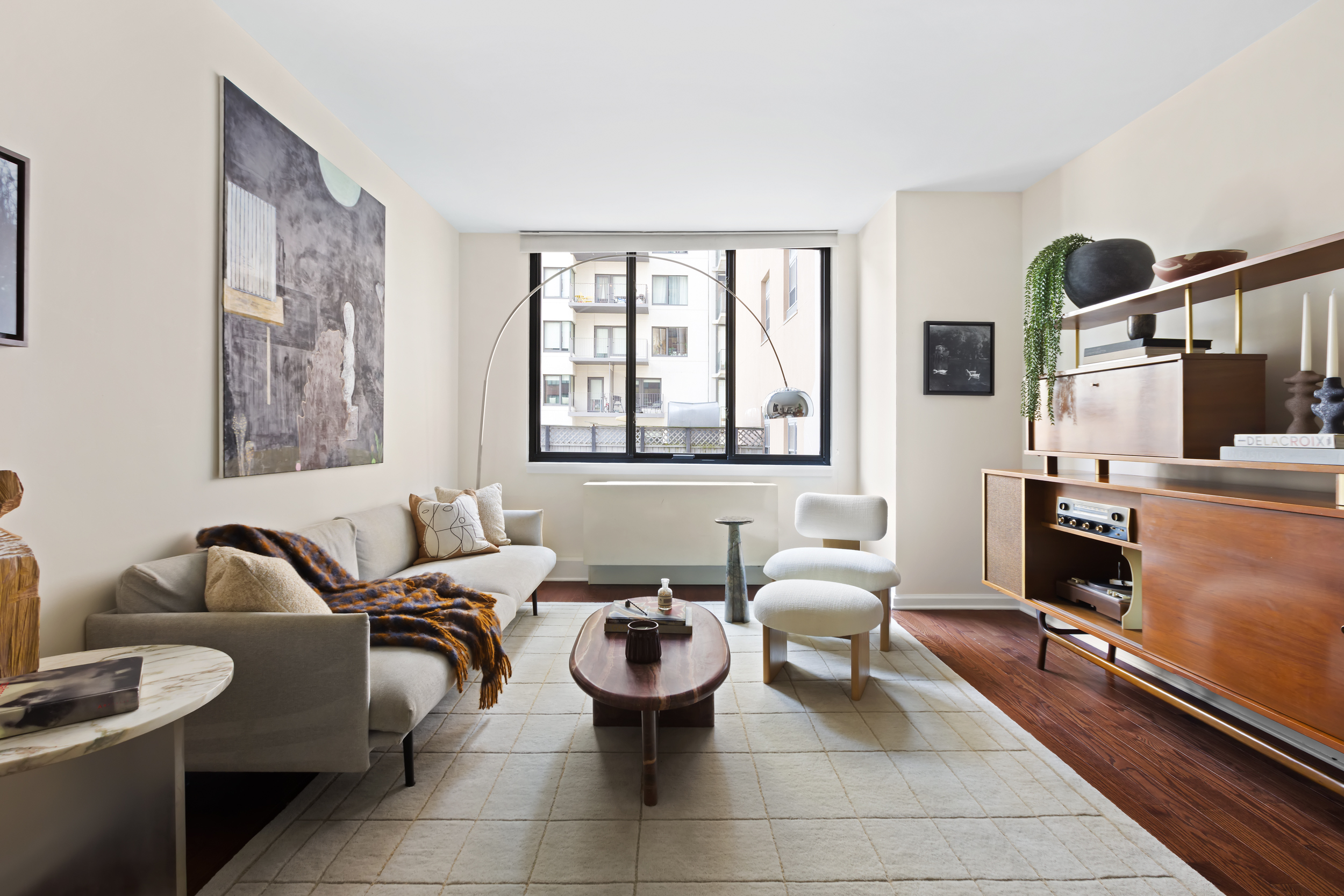 199 Bowery, Unit 3D Manhattan, NY 10002 - Photo 1 of 11 a living room with furniture a flat screen tv and windows