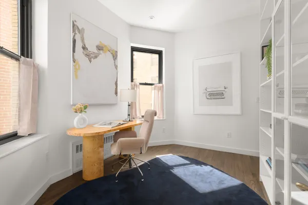 a workspace with wooden floor and a window