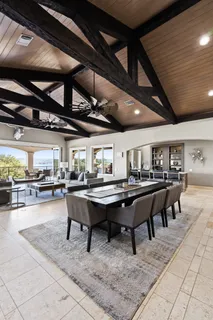 a living room with fireplace furniture and a large window
