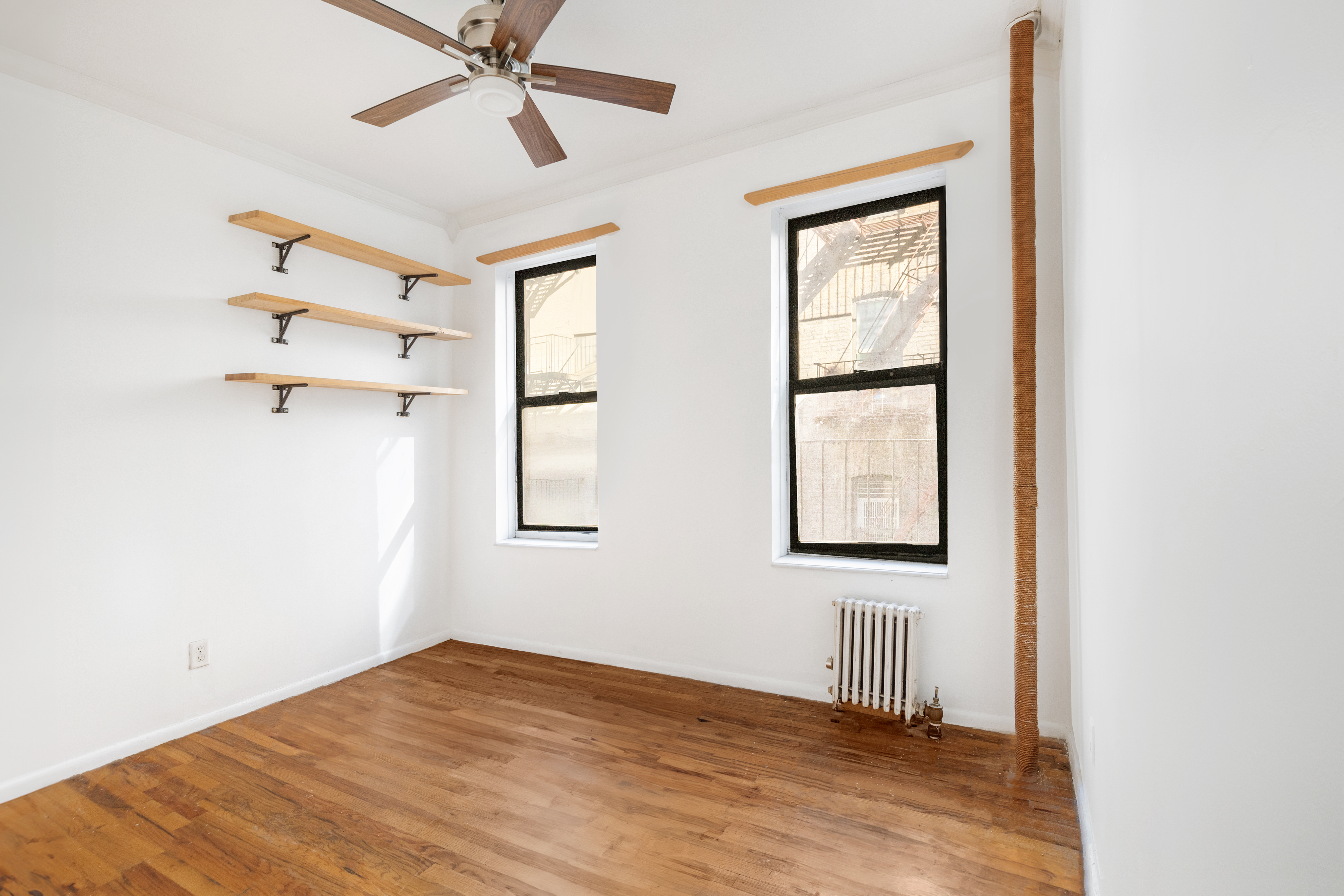 65 West 107th Street, Unit 2D Manhattan, NY 10025 - Photo 3 of 7 a view of empty room with wooden floor and fan